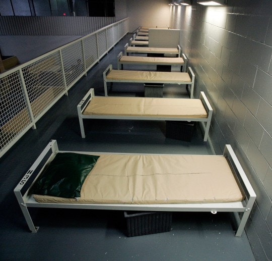 FILE - This Dec. 10, 2008, file photo shows a row of beds at the 
Elizabeth Detention Facility, a Corrections Corporation of America immigration facility in Elizabeth, N.J. CCA, the largest contractor for U.S. Immigration and Customs Enforcement, 
reached a preliminary agreement in May 2010, to soften confinement, free of charge, at nine immigrant facilities covering more than 7,100 beds. ICE officials see the deal, which 
includes Elizabeth, as a precursor to changes elsewhere. (AP Photo/Mel Evans, File)