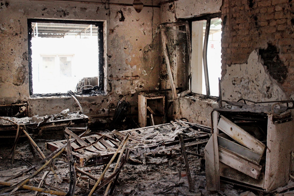 FILE - This Friday, Oct. 16, 2015, file photo shows the charred remains of their hospital after it was hit by a U.S. airstrike in Kunduz, Afghanistan. The U.S. military is paying hundreds of thousands of dollars to wounded survivors and relatives of the 42 Afghans killed when an American AC-130 gunship attacked a hospital run by Doctors Without Borders, which says the “sorry money” doesn’t compensate for the loss of life. (AP Photo/Najim Rahim, File)