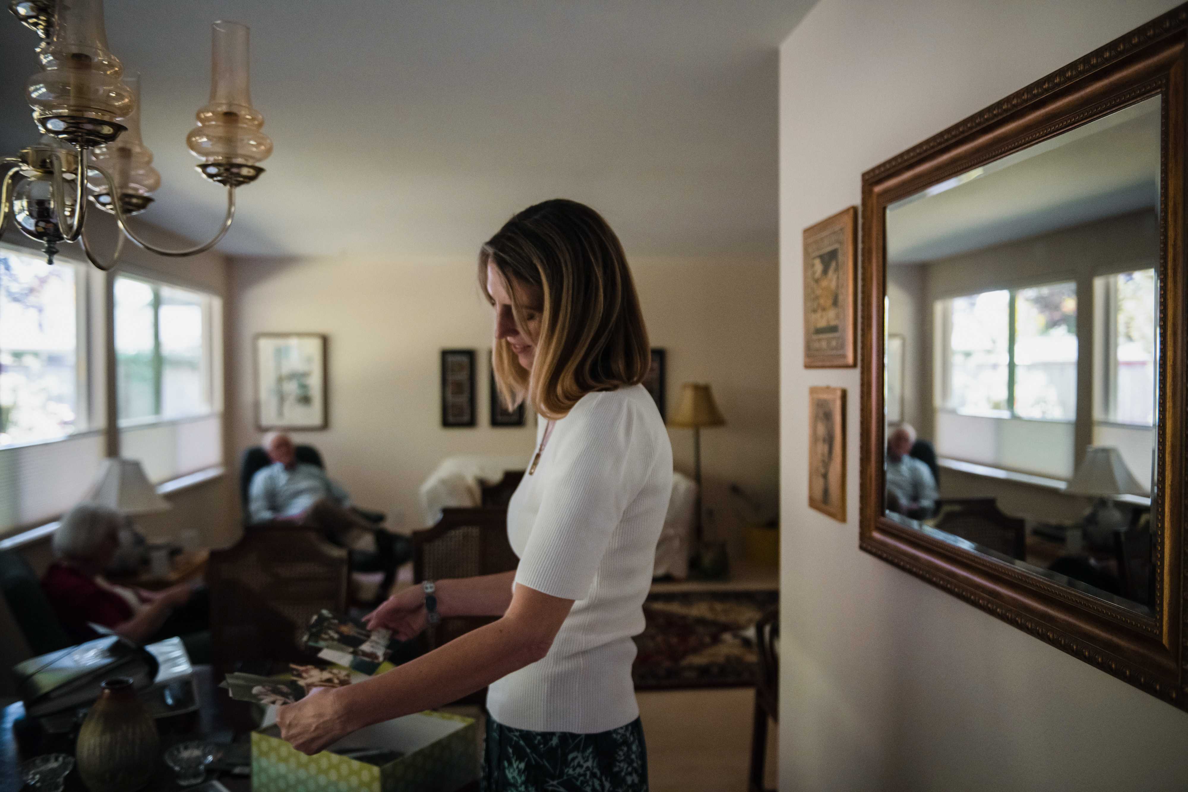Sarah Corrie sifts through old photos of her sister Rachel at home in Olympia, WA July 10, 2022. Kholood Eid for The Intercept