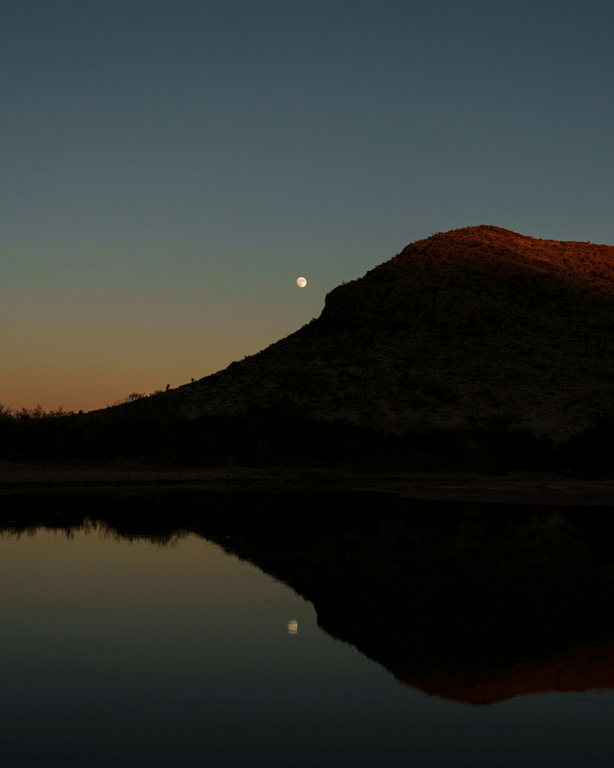 A view from the banks of the Five Mile Tank at sunset where a group of migrants were shot at by Michael and Mark Sheppard in late September, near Sierra Blanca, Texas on Sunday November 6, 2022. 
Photo: Paul Ratje for The Intercept