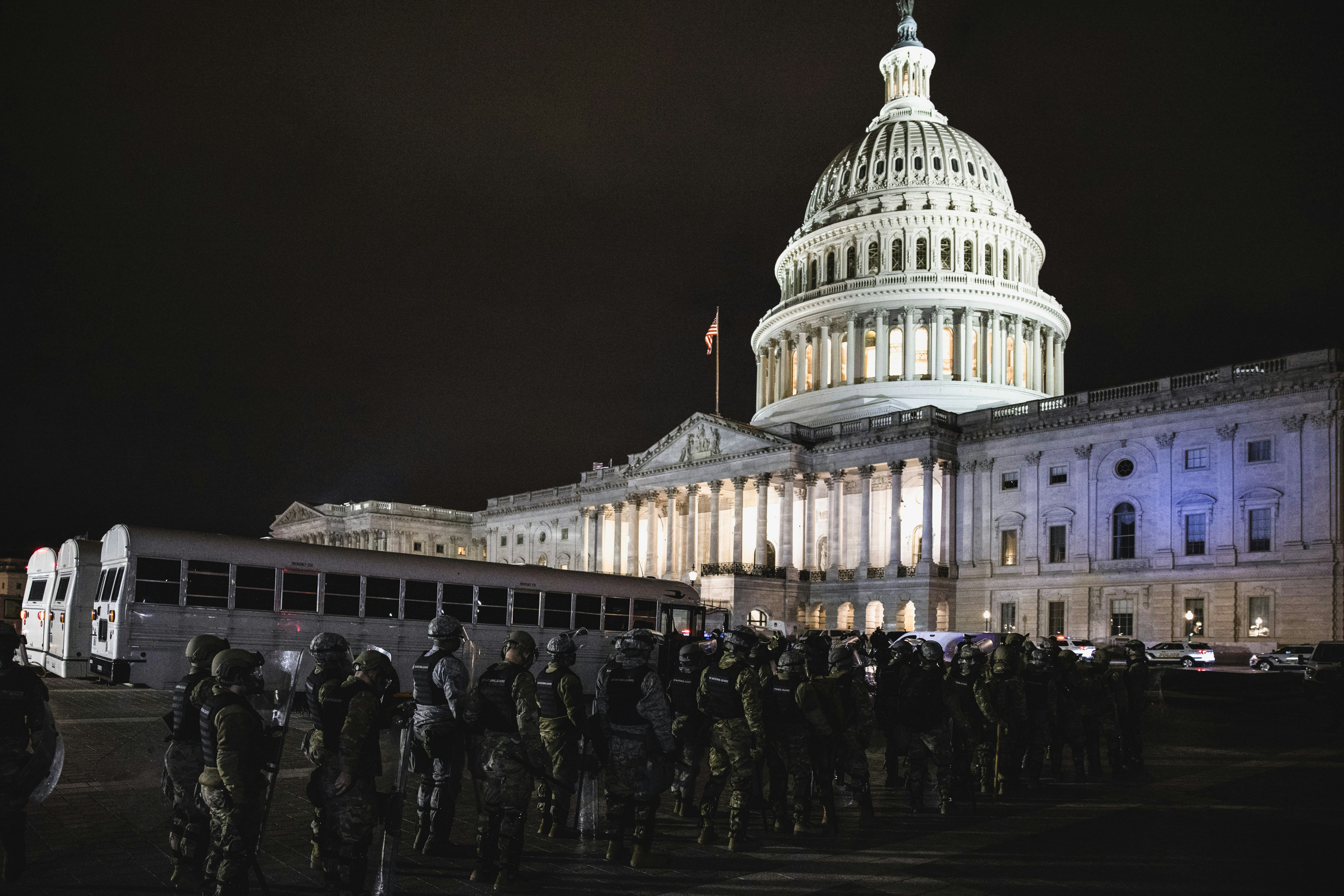 WASHINGTON, DC - JANUARY 06: Members of the National Guard and the Washington D.C. police stand guard to keep demonstrators away from the U.S. Capitol on January 06, 2021 in Washington, DC. A pro-Trump mob stormed the Capitol earlier, breaking windows and clashing with police officers. Trump supporters gathered in the nation's capital to protest the ratification of President-elect Joe Biden's Electoral College victory over President Donald Trump in the 2020 election. (Photo by Samuel Corum/Getty Images)
