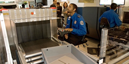 A Transportation Security Administration (TSA) officer reads the X-ray of a laptop computer that rides in a new style bin for carry-ons at the Checkpoint Evolution prototype at Baltimore-Washington International Airport's security screening checkpoint B in the Southwest terminal on April 28, 2008. The checkpoint is calm and quiet with officers wearing headsets to keep radio traffic down and new inspection machines and proceedures.                AFP PHOTO/Paul J. RICHARDS (Photo credit should read PAUL J. RICHARDS/AFP/Getty Images)
