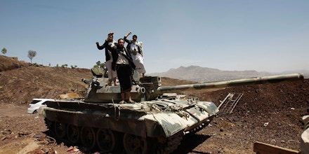 In this photo taken on Monday, Sept. 22, 2014, Hawthi Shiite rebels stand on a tank at the headquarters of the army's 1st Armored Division, in Sanaa, Yemen. (AP Photo/Hani Mohammed)