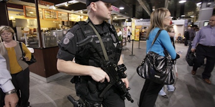 A Massachusetts Bay Transportation Authority Transit police officer carries an assault rifle while patrolling the North Station train station, in Boston, at rush hour Tuesday, Sept. 22, 2009. The government expanded a terrorism warning from transit systems to U.S. stadiums, hotels and entertainment complexes as investigators searched for more suspects Tuesday in a possible al-Qaida plot to set off hydrogen-peroxide bombs hidden in backpacks. (AP Photo/Steven Senne)