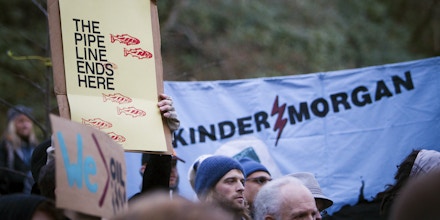 Image #: 33231001    Demonstrators hold signs while protesting against the proposed Kinder Morgan pipeline on Burnaby Mountain in Burnaby, British Columbia November 17, 2014. Kinder Morgan Energy Partners LP said on November 14, 2014 it would resume preliminary work on its Trans Mountain pipeline after a British Columbia court granted an injunction against protesters blocking work crews in the Vancouver suburb of Burnaby. REUTERS/Ben Nelms (CANADA - Tags: CIVIL UNREST ENERGY ENVIRONMENT POLITICS)       REUTERS /BEN NELMS /LANDOV