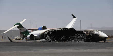 A Felix Airways plane, a domestic airline, destroyed by Saudi-led airstrikes, at the Sanaa International airport, in Yemen, Wednesday, April 29, 2015. Saudi-led coalition warplanes pounded Shiite rebels and their allies overnight and throughout the day on Tuesday in the Yemeni capital. Around midday, airstrikes hit Sanaa International airport, setting a plane owned by a private company on fire, according to a statement released by the Shiite rebels, known as Houthis. (AP Photo/Hani Mohammed)