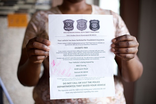 Tracy Martin, 36, of Detroit  holding a flier by Highland Park police who had towed her truck, saying "Multi Jurisdictional Auto Theft Task Force." Sunday, May 17, 2015 in Detroit, Michigan.