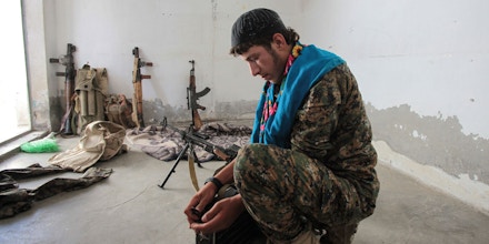 TAL ABYAD, SYRIA - JUNE 19: (TURKEY OUT) A Kurdish People's Protection Units, or YPG fighter controls the weapons in downtown of Tal Abyad, Syria. June 19, 2015. Kurdish fighters with the YPG took full control of Tal Abyad, dealing a major blow to the Islamic State group's ability to wage war in Syria. Mopping up operations have started to make the town safe for the return of residents from Turkey, after more than a year of Islamic State militants holding control of the town. (Photo by Ahmet Sik/Getty Images)