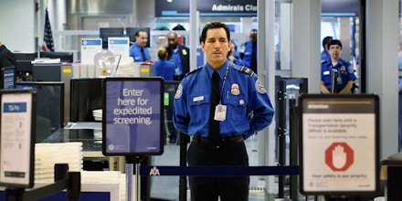 MIAMI, FL - OCTOBER 04: A TSA agent waits for passengers to use the TSA PreCheck lane being implemented by the Transportation Security Administration at Miami International Airport on October 4, 2011 in Miami, Florida. The pilot program launched today for fliers to use the expedited security screening in Miami, Atlanta, Detroit and Dallas/Fort Worth.The lane has a metal detector rather than a full-body imaging machine and passengers will no longer no need to remove shoes, belts, light outerwear, and bags of liquids that are compliant with TSA restrictions.  (Photo by Joe Raedle/Getty Images)