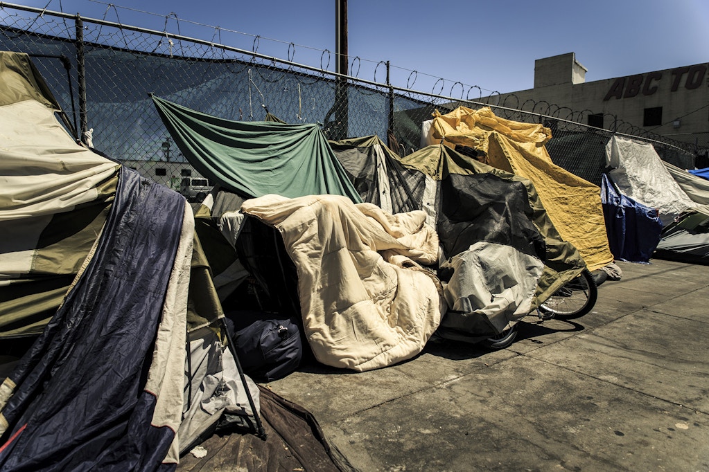 A block-long encampment running down San Pedro St houses a multitude of homeless people. Most of these people use tents makeshift plastic coverings and blankets to protect them from the often harsh summer L.A. weather.