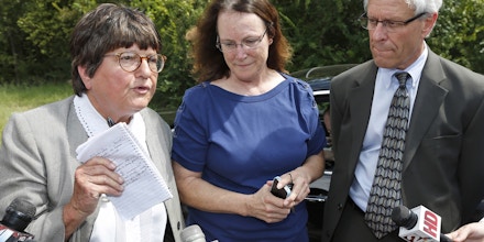Kathleen Lord, center, and Don Knight, right, two of Richard Glossip's defense attorneys, look on as Sister Helen Prejean, left, addresses the media outside the Oklahoma State Penitentiary in McAlester Okla., Wednesday, Sept. 16, 2015, after a stay was issued for Glossip. Glossip was twice convicted of ordering the killing of Barry Van Treese, who owned the Oklahoma City motel where he worked. His co-worker, Justin Sneed, was convicted of fatally beating Van Treese and was a key prosecution witness in Glossip's trials. (AP Photo/Sue Ogrocki)