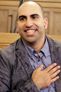 Steve Salaita, a professor who lost a job offer from the University of Illinois over dozens of profane Twitter messages that critics deemed anti-Semitic speaks to students and reporters during a news conference at the University of Illinois campus Tuesday, Sept.  9, 2014, in Champaign Ill.  (AP Photo/Seth Perlman)