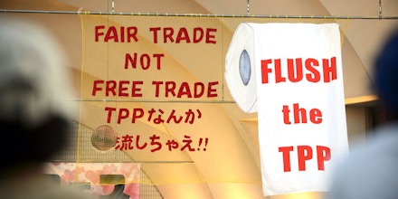 Signs are displayed during a protest against the Trans-Pacific Partnership (TPP) trade agreement at Yoyogi Park in Tokyo, Japan, on Tuesday, May 26, 2015. A former Japanese agriculture minister is suing the government over a U.S.-led Pacific trade agreement supported by Prime Minister Shinzo Abe, claiming it threatens Japans food security and farm industry. Photographer: Akio Kon/Bloomberg via Getty Images