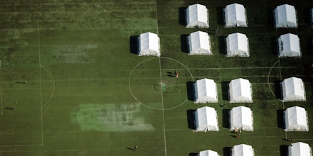 Aerial view of tents at a camp for asylum-seekers on the grounds of the former army barracks Schmidt-Knobelsdorf-Kaserne in Berlin on September 9, 2015. Germany has said it is expecting to welcome 800,000 asylum-seekers this year, four times more than a year ago and far more than any other EU countries.  AFP PHOTO / DPA / RALF HIRSCHBERGER +++ GERMANY OUT        (Photo credit should read RALF HIRSCHBERGER/AFP/Getty Images)