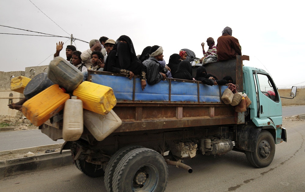 Image #: 36701899    Internally displaced people ride on the back of a truck as they flee in the district of Khamir of Yemen's northwestern province of Amran May 9, 2015. They were forced to leave their homes in the nearby province of Saada amid Saudi-led air strikes. REUTERS/Mohamed al-Sayaghi /LANDOV