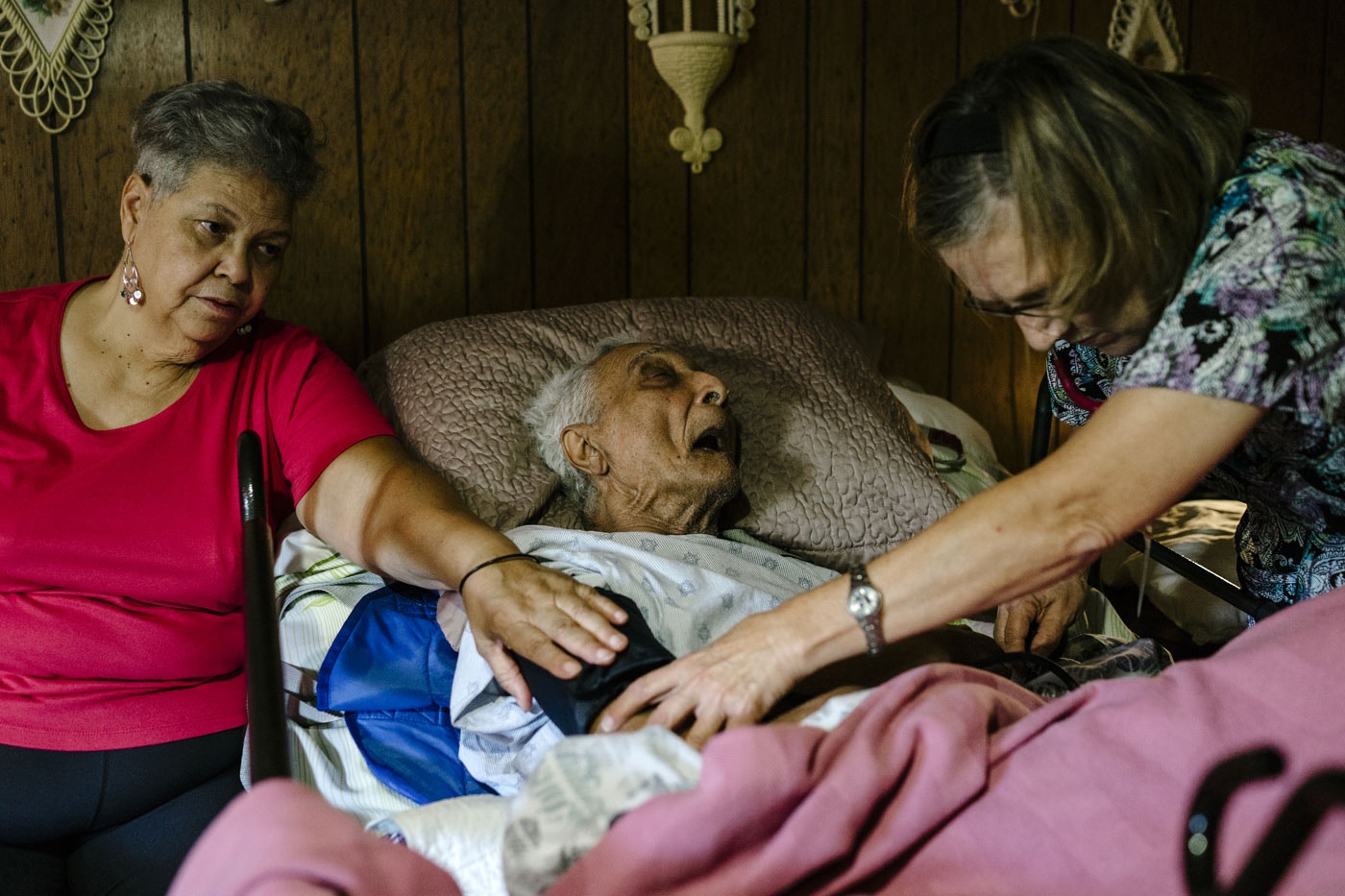 Judy Montgomery (L), 65, sits next to her father, Vallery Montgomery, 89, as nurse Laura Bull performs a checkup, Oct. 22, 2015, Westlake, La.