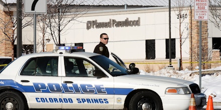 COLORADO SPRINGS, CO - NOVEMBER 30: A Colorado Springs Police officer guards the entrance to a Planned Parenthood facility in Colorado Spring where authorities continue to process the crime scene, November 30, 2015. A gunmen killed three people at  Planned Parenthood facility last Friday. (Photo by RJ Sangosti/The Denver Post via Getty Images)