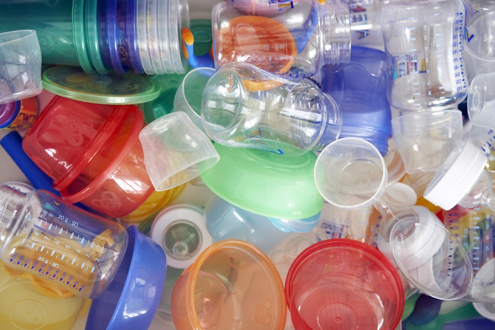 Plastic baby bottles and dishes, close-up