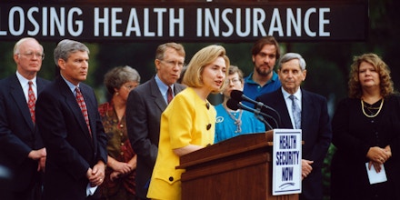 16 Aug 1994, Washington, DC, USA --- First Lady Hillary Rodham Clinton speaks in front of a counter which shows one person losing health insurance every 1.17 seconds. --- Image by © Reuters/CORBIS