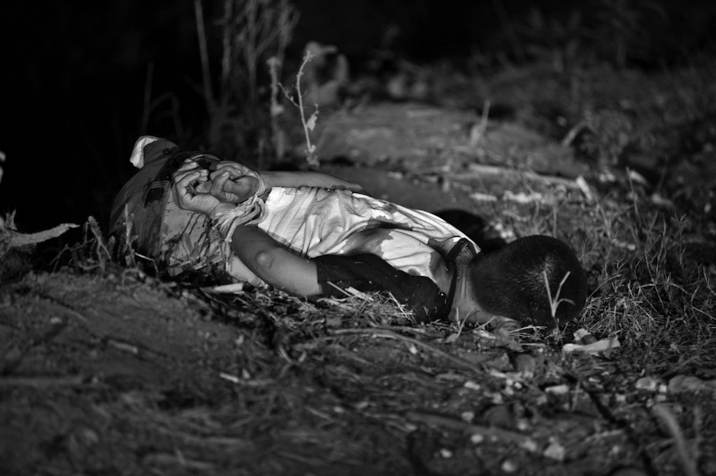 March 7, 2012 - Culiacan, Sinaloa, Mexico - A man with hands bound behind his back and killed execution style on the banks of a river. Culiacan is the cradle of many of the drug cartels and their leaders in Mexico. (Credit Image: © Louie Palu/zReportage/ZUMA)