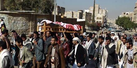 Yemeni mourners carry the body of Almigdad Mojalli, a freelance Yemeni journalist who was killed in an air raid by the Saudi-led coalition, during his funeral on the outskirts of Sanaa on January 18, 2016. Mojalli was hit by shrapnel as a missile slammed into the capital's southern Jaref suburb while he was covering air strikes, said his colleague, photojournalist Bahir Hameed. / AFP / MOHAMMED HUWAIS (Photo credit should read MOHAMMED HUWAIS/AFP/Getty Images)