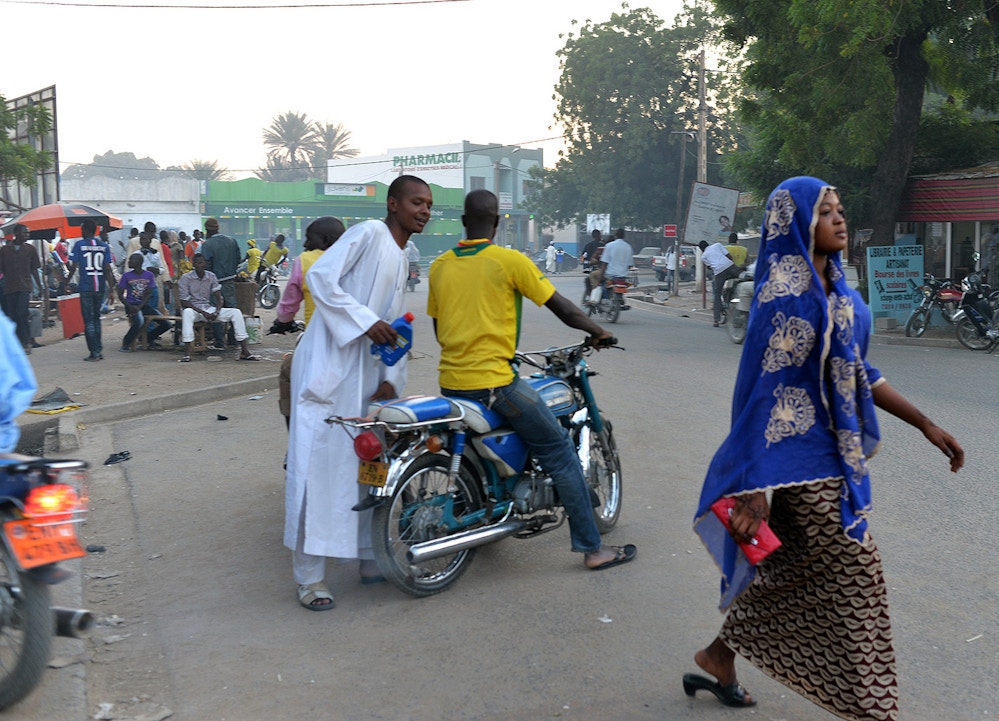 People walk along a main street in Maroua, the capital of the far northern region of Cameroon, on November 11, 2014.