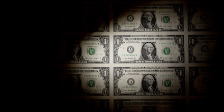 A sheet of uncut U.S. $1 bills is arranged for a photograph in Washington, D.C., U.S., on Thursday, Feb. 6, 2014. A suspension of the federal debt limit, enacted by Congress in October, is scheduled to expire Feb. 7. Treasury Secretary Jacob J. Lew has urged lawmakers to act quickly to raise the cap, saying the government
