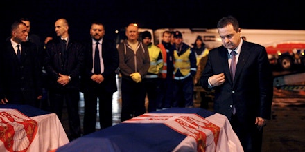 Serbian Foreign Minister Ivica Dacic (R) stands next to the coffins of two Serbian embassy staff abducted in Libya, at Belgrade's Nikola Tesla airport, Serbia, February 23, 2016. REUTERS/Djordje Kojadinovic (Newscom TagID: rtrlseven658773.jpg) [Photo via Newscom]