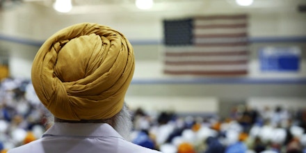 OAK CREEK, WI - AUGUST 10:  Family and friends and community members gather at Oak Creek High School to mourn the loss of 6 members of the Sikh Temple of Wisconsin on August 10, 2012 in Oak Creek, Wisconsin. Bhai Seeta Singh, Bhai Parkash Singh, Bhai Ranjit Singh, Satwant Singh Kaleka, Subegh Singh, and Parmjit Kaur Toor were killed when Wade Michael Page, a suspected white supremacist, went on a shooting rampage at the temple August 5. Page also died at the temple after being shot by police then shooting himself.  (Photo by Scott Olson/Getty Images)