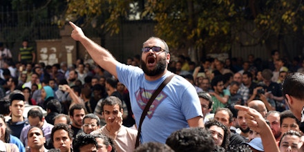 An Egyptian protester shouts slogans during a demonstration against a controversial deal to hand two islands in the Red Sea to Saudi Arabia on April 15, 2016 outside the Journalists' Syndicate in central Cairo. Outside the Journalists' Syndicate in central Cairo, about 200 protesters chanted 