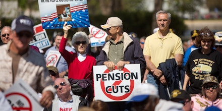 WASHINGTON, D.C. - APRIL 14: Attendees rally on the West Front of the U.S. Capitol building with Teamsters Union retirees who traveled from across the country to voice their opposition to deep cuts to their pension benefits on April 14, 2016, in Washington, D.C. Thousands are facing massive pension cuts because of a law called the Multiemployer Pension Reform Act of 2014 (MPRA). (Photo by Allison Shelley/Getty Images)