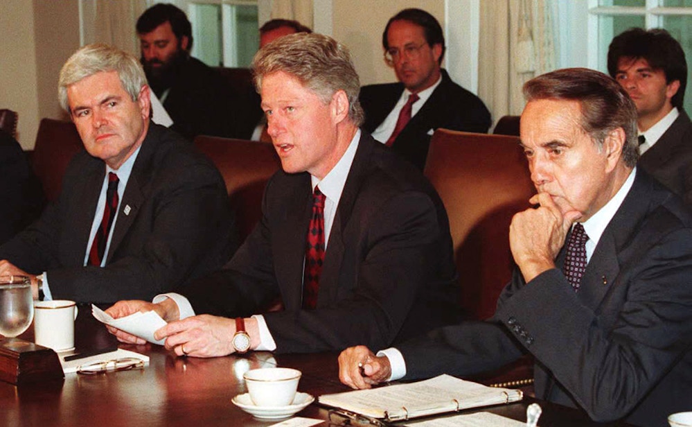 WASHINGTON, DC - APRIL 26:  US President Bill Clinton (C) sits between US House of Representatives Speaker Newt Gingrich (L) and Senate Majority Leader Bob Dole (R) during a 26 April meeting at the White House in which Clinton pushed for more federal workers to combat terrorism. Earlier today, Clinton attended the funeral of a Secret Service agent who was killed in the Oklahoma City bombing. AFP PHOTO  (Photo credit should read LUKE FRAZZA/AFP/Getty Images)