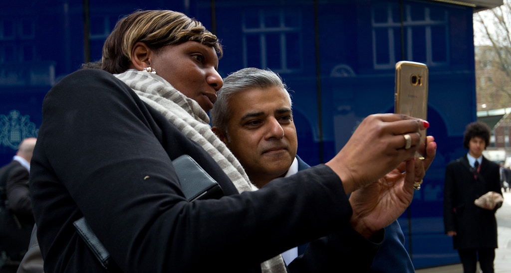 LONDON, ENGLAND - APRIL 21: Labour Mayoral Candidate Sadiq Khan poses for a selfie with members of the public during a visit to Scotland Yard on April 21, 2016 in London, England. Sadiq Khan is currently one of the main contenders running against Conservative candidate Zac Goldsmith as both parties campaign ahead of the election on May 5th. (Photo by Ben Pruchnie/Getty Images)