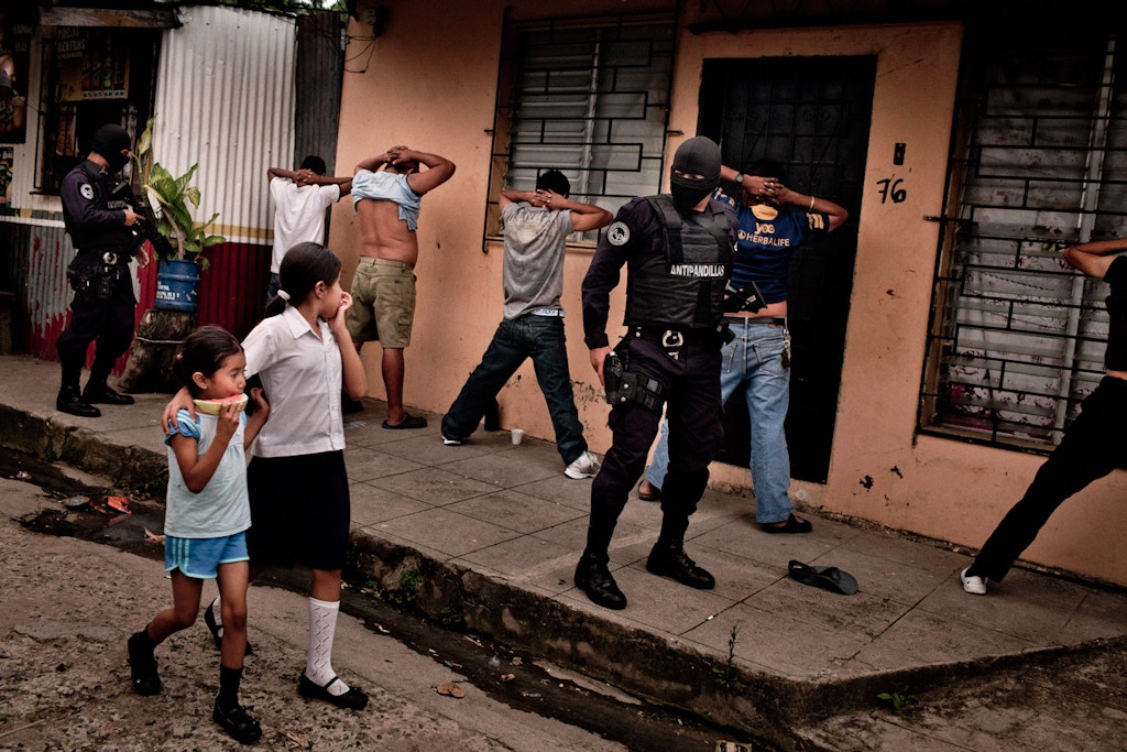 Members of a police anti-gang force search men in San Salvador, El Salvador. Aug. 14, 2012. Authorities believe peace talks involving the two largest street gangs in the country, the Mara Salvatrucha and Barrio 18, have led to a precipitous drop in violence in El Salvador, one of the hemisphere's most violent countries. (Tomas Munita/The New York Times)