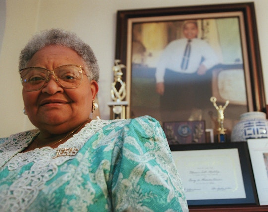 Mamie Till Mobley stands before a portrait of her slain son, Emmett Till, in her Chicago home on July 28, 1995. Since Emmett's lynching 40 years ago, Mobley has been committed to making sure that his death is remembered and never repeated. Till was kidnapped, tortured and lynched for allegedly whistling at a white woman in a small Mississippi town. (AP Photo/Beth A. Keiser)