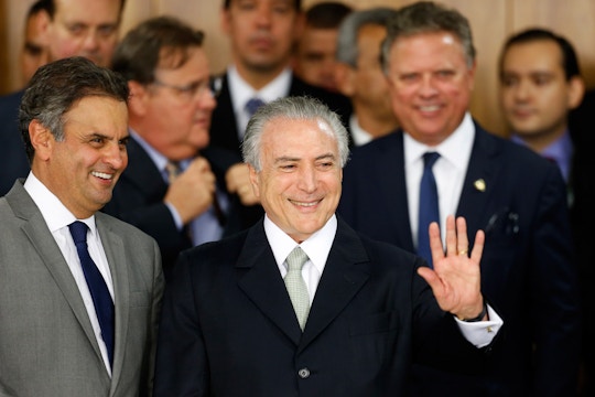 BRASILIA, BRAZIL - MAY 12: Brazil's interim President Michel Temer (R) waves with Senator Aecio Neves (L) at a signing ceremony for new government ministers at the Planalto presidential palace after the Senate voted to accept impeachment charges against suspended President Dilma Rousseff on May 12, 2016 in Brasilia, Brazil. Rousseff has been suspended from her presidential duties and will face a Senate trial for alleged manipulation of government accounts. (Photo by Igo Estrela/Getty Images)