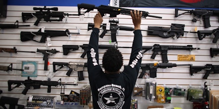 POMPANO BEACH, FL - APRIL 11:  As the U.S. Senate takes up gun legislation in Washington, DC , Mike Acevedo puts a weapon on display at the National Armory gun store on April 11, 2013 in Pompano Beach, Florida. The Senate voted 68-31 to begin debate on a bill that would significantly expand background checks for gun sales.  (Photo by Joe Raedle/Getty Images)
