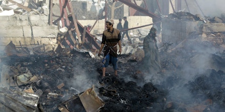 Yemenis inspect the damage at a sewing workshop that was hit by a Saudi-led coalition air strike in the capital Sanaa, on February 14, 2016.The factory owner, Faisal al-Musaabi, told AFP that two employees, including a 14-year-old boy, were killed and 15 others wounded in the overnight air raid. / AFP / MOHAMMED HUWAIS (Photo credit should read MOHAMMED HUWAIS/AFP/Getty Images)