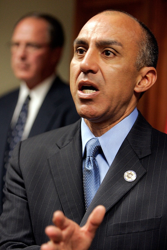Michael Ramos, San Bernardino County District Attorney, speaks during a news conference as the county sheriff Gary Penrod listens in the background Tuesday, March 7, 2006, in San Bernardino, Calif. Ramos announced that his office filed a charge of Attempted Voluntary Manslaughter against San Bernardino County Sheriff's Deputy Ivory Webb in the shooting of Elio Carrion.   (AP Photo/Ric Francis)