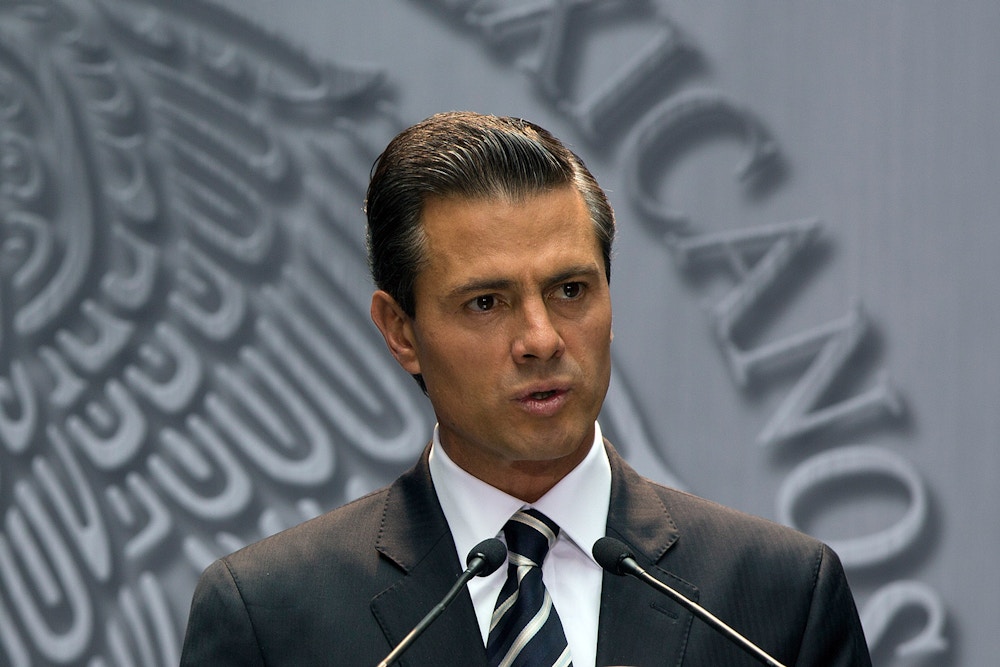 Enrique Pena Nieto, Mexico's president, speaks about the killing of students in Iguala, Mexico, during remarks at the National Palace in Mexico City, Mexico, on Monday, Oct. 6, 2014. Gang members acting in concert with local police allegedly killed 17 college students following a clash just over a week ago, according to a state prosecutor. Pena Nieto condemned the deaths as "painful and unacceptable" and vowed to bring the perpetrators to justice. Photographer: Susana Gonzalez/Bloomberg via Getty Images