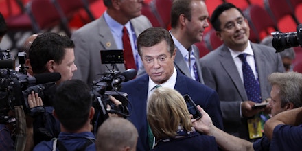 Trump Campaign Chairman Paul Manafort is surrounded by reporters on the floor of the Republican National Convention in Cleveland, Sunday, July 17, 2016. Donald Trump's presidential campaign has hired new staffers to manage the efforts of newly named vice presidential candidate Gov. Mike Pence of Indiana. (AP Photo/J. Scott Applewhite)