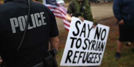RICHARDSON, TX - DECEMBER 12: Police patrol the area where protesters from the so-called Bureau of American-Islamic Relations (BAIR), take part in a demonstration in front of the Islamic Association of North Texas at the Dallas Central Mosque on December 12, 2015 in Richardson, Texas. About two dozen members of the group protested in front of the mosque, as counter-protesters demonstrated across the street. The Dallas area had become a focal point for Islamophobia, even before the Islamic extremist-inspired mass shooting on December 2, 2015 in San Bernadino, California.  (Photo by John Moore/Getty Images)