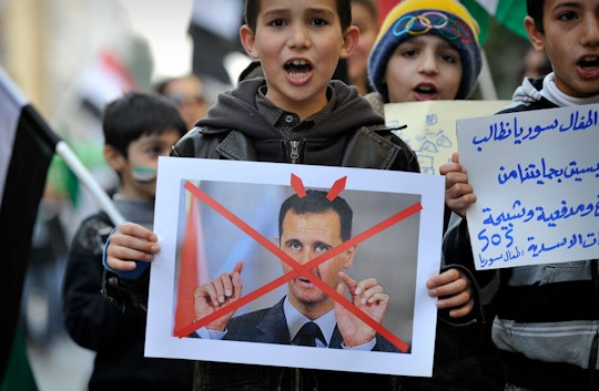 Syrian children living in Athens take part in a demonstration against Syrian President Bashar al-Assad in Athens on March 15, 2012, marking  the first anniversary of the anti-regime revolt. AFP PHOTO / LOUISA GOULIAMAKI (Photo credit should read LOUISA GOULIAMAKI/AFP/Getty Images)