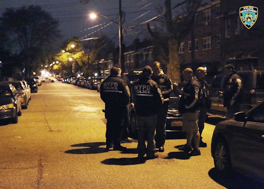 In this photo provided by the New York City Police Department, officers gather at a location in the Bronx borough of New York during a takedown of two rival drug gangs in the early hours of Wednesday, April 27, 2016. According to the U.S. Attorney, nearly 700 New York Police Department officers and federal agents accompanied by helicopters and armored trucks executed pre-dawn raids, taking down the rival drug gangs from top to bottom. (New York Police Department via AP)