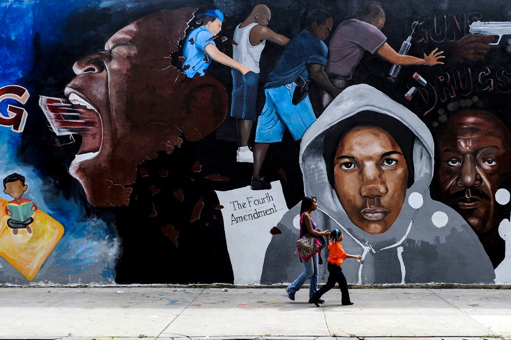 A street mural depicts police officers using the stop-and-frisk tactic in New York, Aug. 20, 2012.