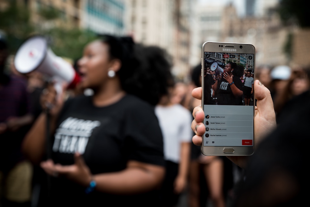 A demonstrator live streams the march on Facebook Sunday in Union Square. Following several police involved shootings of black men throughout America, hundreds of emotionally effected people turned to the streets to demonstrate and fight for change.  Demonstrators marched from Times Square to Union Square in New York City on July 10, 2016. (Monica Jorge) *** Please Use Credit from Credit Field ***