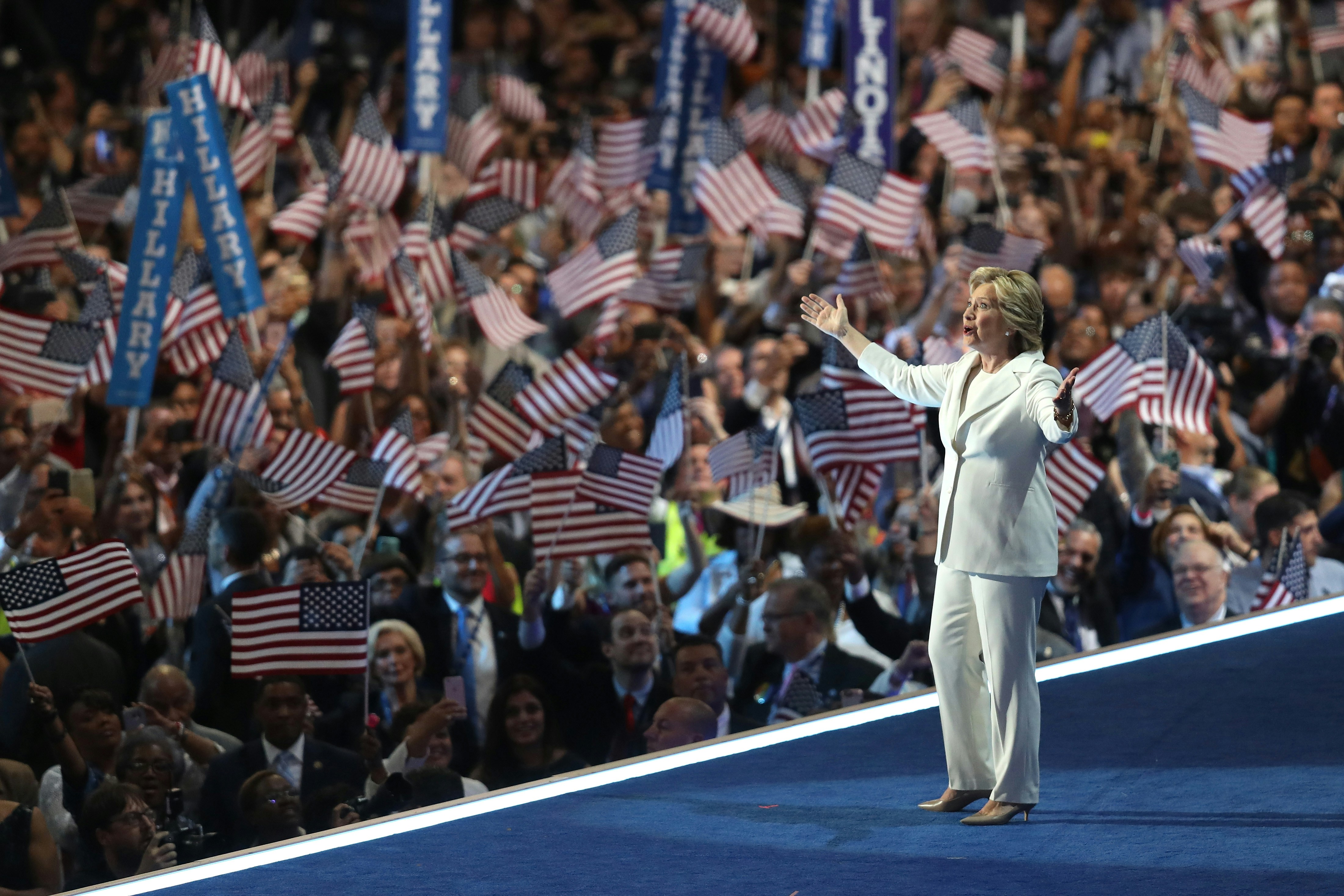 PHILADELPHIA, PA - JULY 28:  Democratic presidential nominee Hillary Clinton acknowledges the crowd as she arrives on stage during the fourth day of the Democratic National Convention at the Wells Fargo Center, July 28, 2016 in Philadelphia, Pennsylvania. Democratic presidential candidate Hillary Clinton received the number of votes needed to secure the party's nomination. An estimated 50,000 people are expected in Philadelphia, including hundreds of protesters and members of the media. The four-day Democratic National Convention kicked off July 25.  (Photo by Joe Raedle/Getty Images)