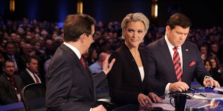 DES MOINES, IA - JANUARY 28:  Moderators Chris Wallace (L) pats on the shoulder of Megyn Kelly (2nd L) as they wait with Bret Baier (R) for the beginning of the Fox News - Google GOP Debate January 28, 2016 at the Iowa Events Center in Des Moines, Iowa. Residents of Iowa will vote for the Republican nominee at the caucuses on February 1. Donald Trump, who is leading most polls in the state, decided not to participate in the debate.  (Photo by Alex Wong/Getty Images)