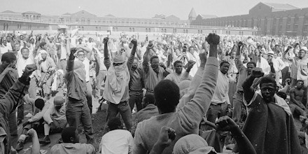 Inmates at Attica State Prison in Attica, New York raise their fists in a show of unity on Sept. 1971, during the Attica uprising, which took the lives of 43 people.