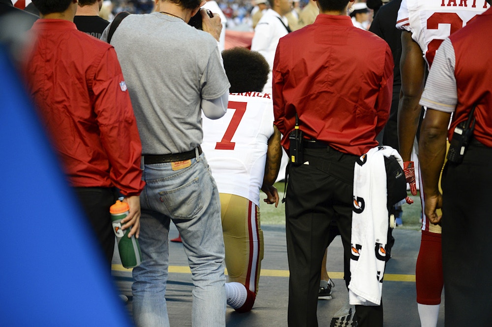 San Francisco 49ers quarterback Colin Kaepernick, middle, kneels during the national anthem before the team's NFL preseason football game against the San Diego Chargers, Thursday, Sept. 1, 2016, in San Diego. (AP Photo/Denis Poroy)
